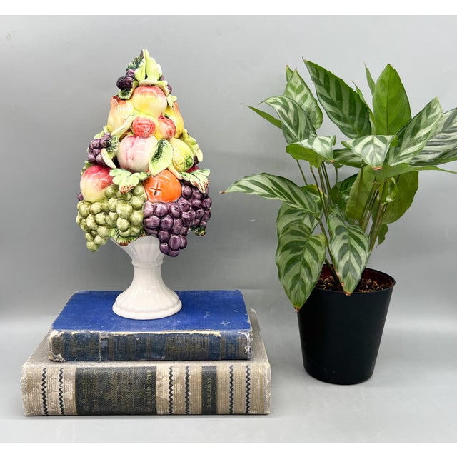 Striking vintage Italian-attributed ceramic fruit topiary featuring a lush, dimensional arrangement of grapes, pears,...