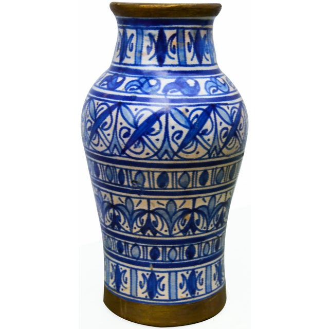Handcrafted and glazed ceramic vase with ornate blue pattern and intricate brass inlay. No maker's mark. This beautiful...