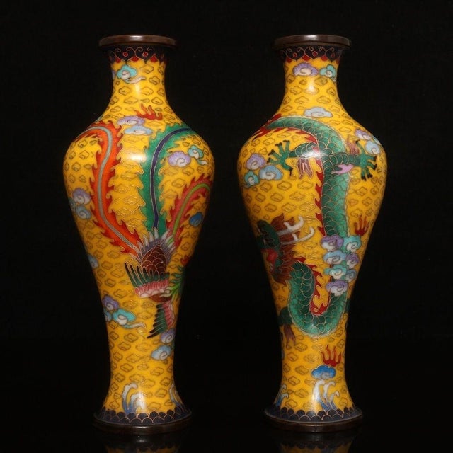 This is a striking and vibrant pair of matching cloisonné enamel vases. Featuring an elegant, elongated baluster form...