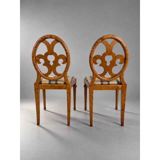 Swedish Grace Side Chairs in Birch with Sculptural Openwork Backs, 1920s An elegant pair of Swedish Grace side chairs from...