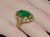 This ring features a stunning 6.64CT natural oval-cut emerald bezel set in rich solid 18K yellow gold. The center emerald...