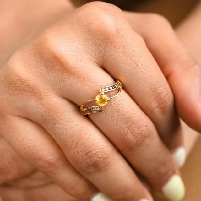 This is part of Chairish’s Fine Jewelry assortment. Certified Yellow Sapphire Ring with Diamonds Set in 18K Gold featuring...