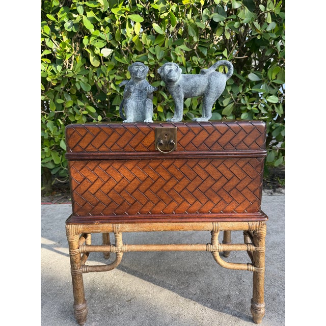 A pair of patinated cast metal monkey sculptures with richly textured surfaces and an aged verdigris finish. The set...