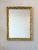 A mid century rectangular gold gilt plaster wall mirror. Whimsical “ribbon-motif” relief. Lovely aged patina. May be hung...