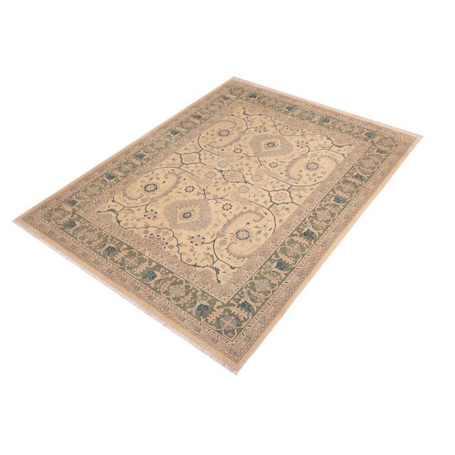 Enhance the ambiance of your home with this magnificent Persian-influenced Turkish hand-knotted rug made by skilled...
