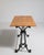 A compact French early 20th century bistro side table with a cast iron base and wooden top, designed for smaller seating...