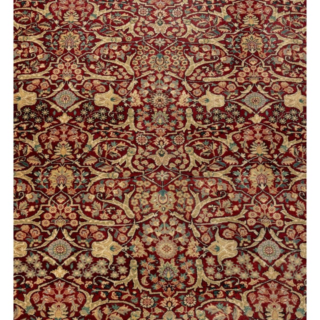 Persian Qum Silk Rug, with floral motif repeating pattern on a red ground. 12' 7" L x 6' W. Provenance: From a Park Avenue...