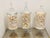 Large collection of natural sea shells in three large apothecary glass jars with covers.
