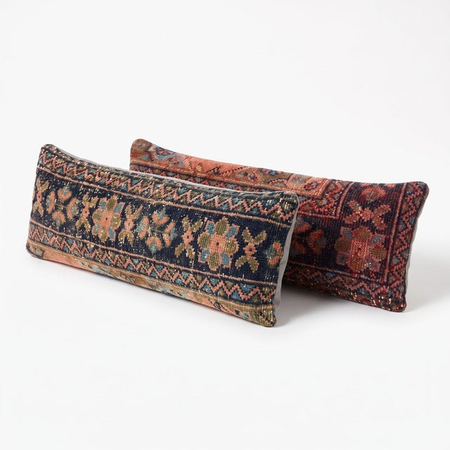 This 12'' x 35'' pillow cover set was made from authentic Turkish rug pieces — plum and navy ground with faded pink...