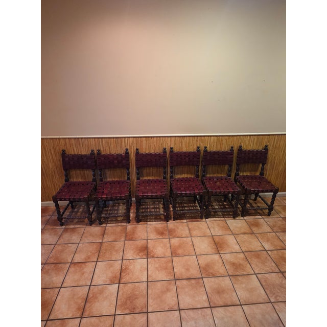 vintage Spanish Revival or Castilian-style dining chair, featuring turned wooden legs, spindle accents, and an interlaced...
