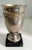 A wonderful Silver cup with a brass band detail on a marble or granite base. The cup, while perfectly suited for a small...