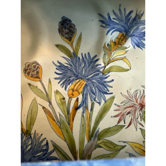 This exceptional Porquier Beau basket is exuberantly painted with blue and pink Bachelor Button flowers. The yellow handle...