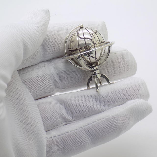A charming vintage miniature depicting a rotating globe, handmade in Continental Silver (800/000) in Arezzo between the...