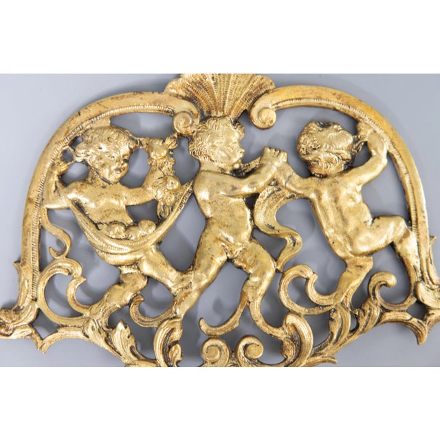 A lovely antique 19th Century French gilded bronze doré farandole of cherubs / putti wall swag ornament. This beautiful...