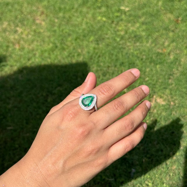 This luxurious cocktail ring features a 3.74-carat, pear-shaped emerald set in 18K white gold. The emerald measures...