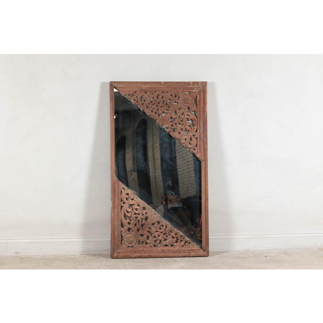 An early 20th-century mirror repurposed from an architectural element, this piece captures the essence of intricate...