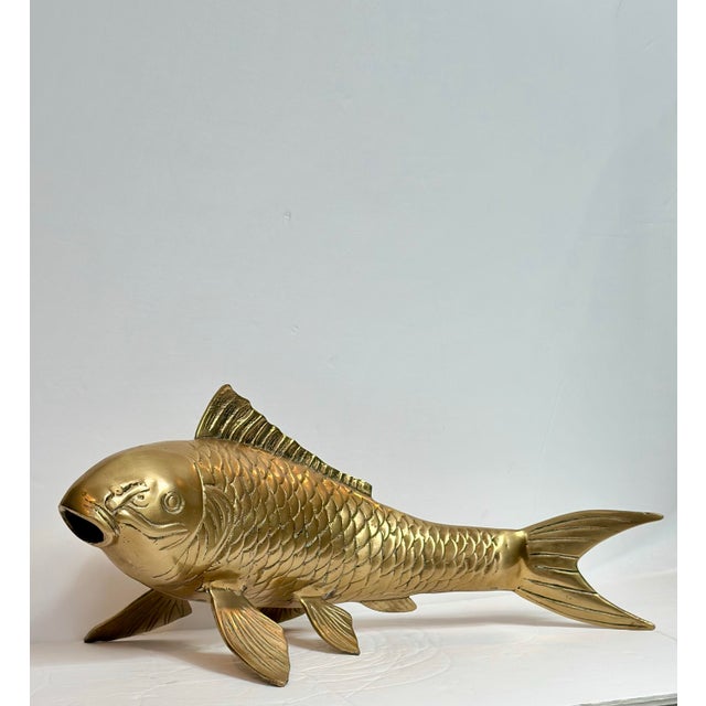 We are very pleased to offer a striking 1980s solid brass koi fish sculpture, celebrated for its graceful form and...