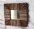 distinctive square wall mirror features a handcrafted frame composed of natural wood and driftwood pieces arranged in a...
