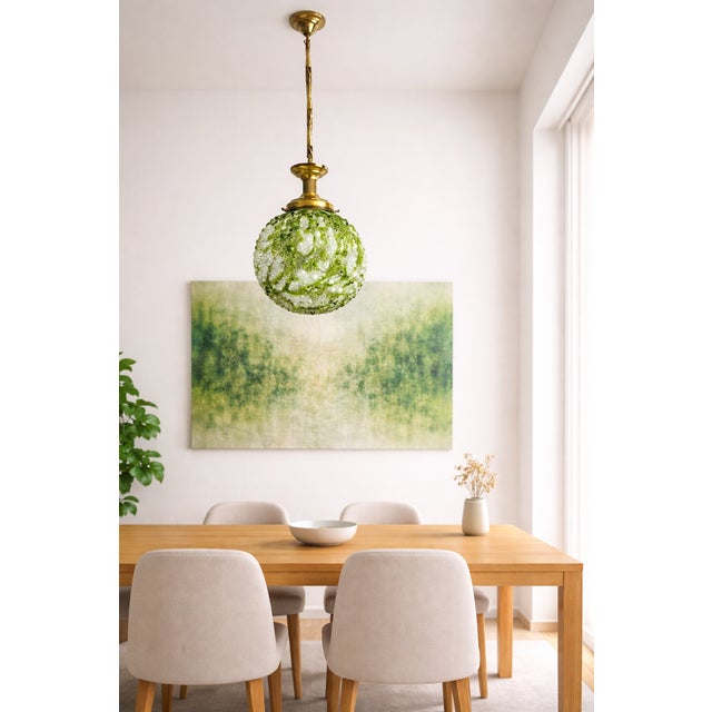 Mid-20th-century pendant light with a hand-blown art glass globe, characteristic of European studio glass lighting from...