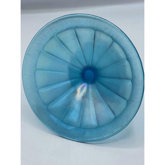 This antique blue stretch glass compote has a flared rim with a footed pedestal, circa 1920’s. The Stretch glass...