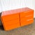 This Postmodern Tangerine Orange Waterfall Dresser is a striking statement piece that embodies the playful geometry and...