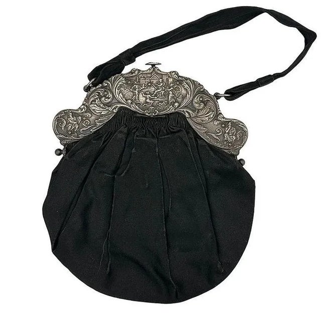 Being offered is a rare circa 1890 sterling silver purse frame and velvet handle, in the an Victorian motif, the frame...