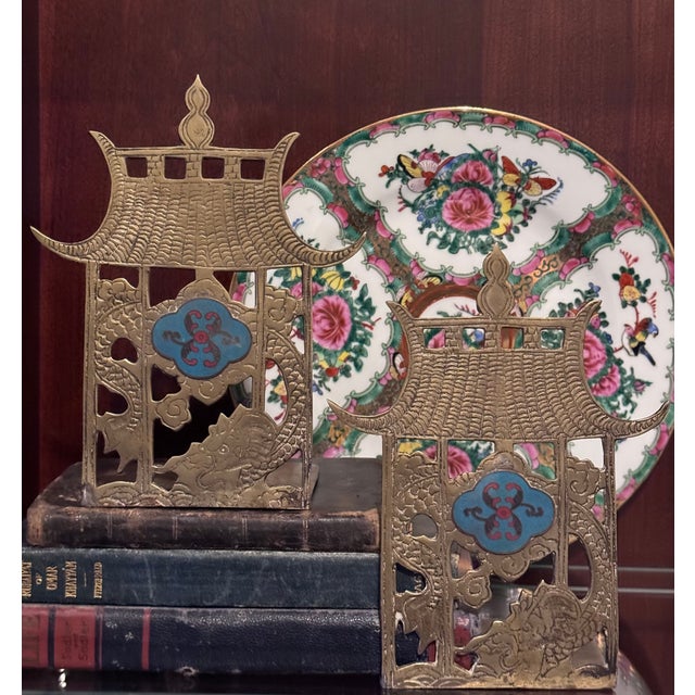 Here is a pair of special, increasingly rare vintage pagoda form brass bookends with dragon motif and center turquoise and...