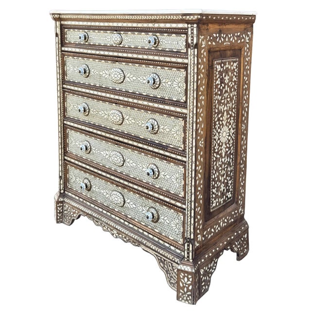 Exotic handcrafted mother of pearl inlaid chest with drawers with natural marble top. The mix between geometric and floral...