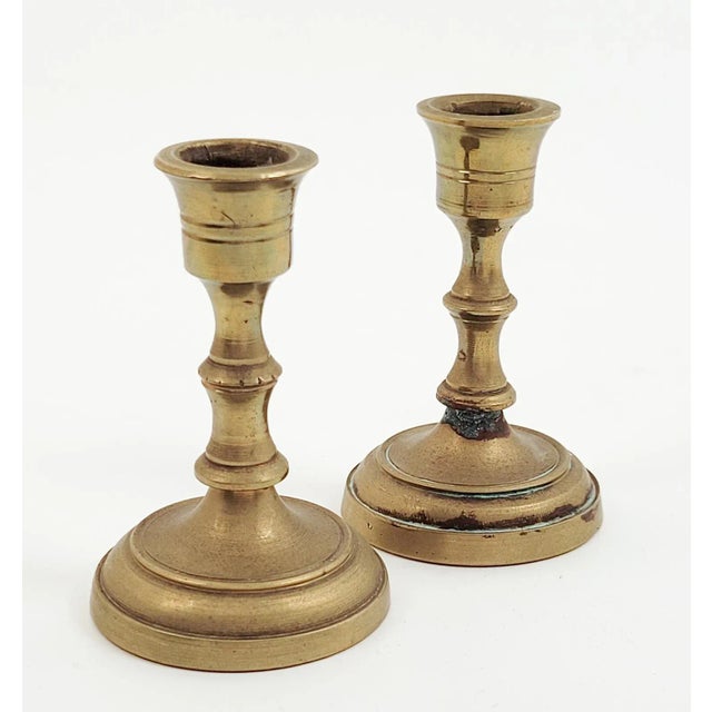 A pair of Continental brass candlesticks, circa 1750.