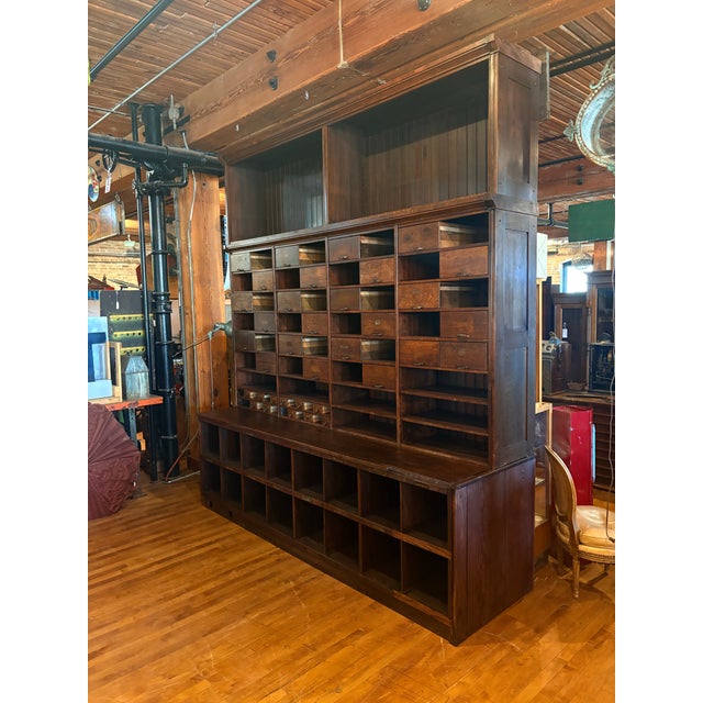 A rare and rather imposing beast of American industrial furniture, this apothecary/post office sorting cabinet boasts...
