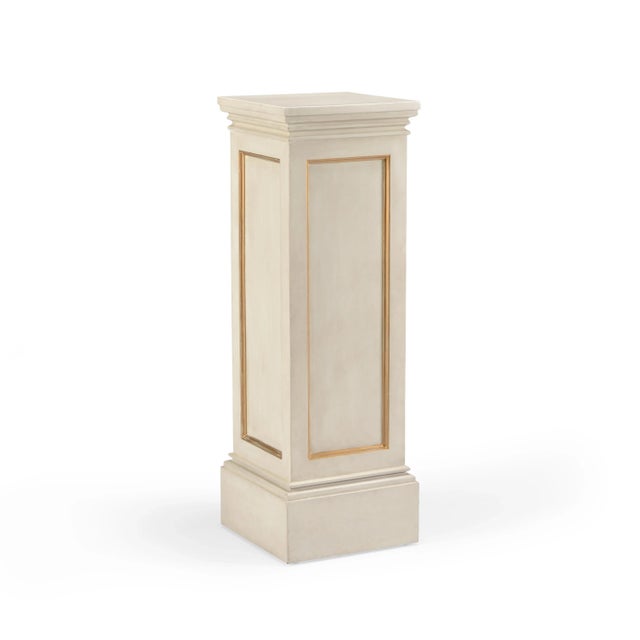This is a gilt pedestal by Chelsea House Inc. The piece is rendered in hand-finished wood.