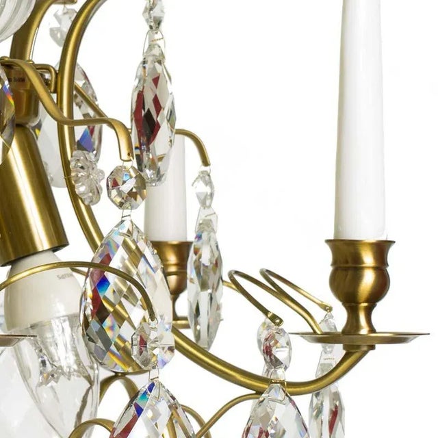 A light brass (cognac coloured) 5 arm baroque style chandelier hand pinned with almond shaped crystals. This chandelier is...