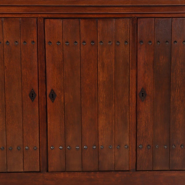 Striking French Brutalist oak cabinet dating to circa 1960, featuring a clean architectural form and robust construction....