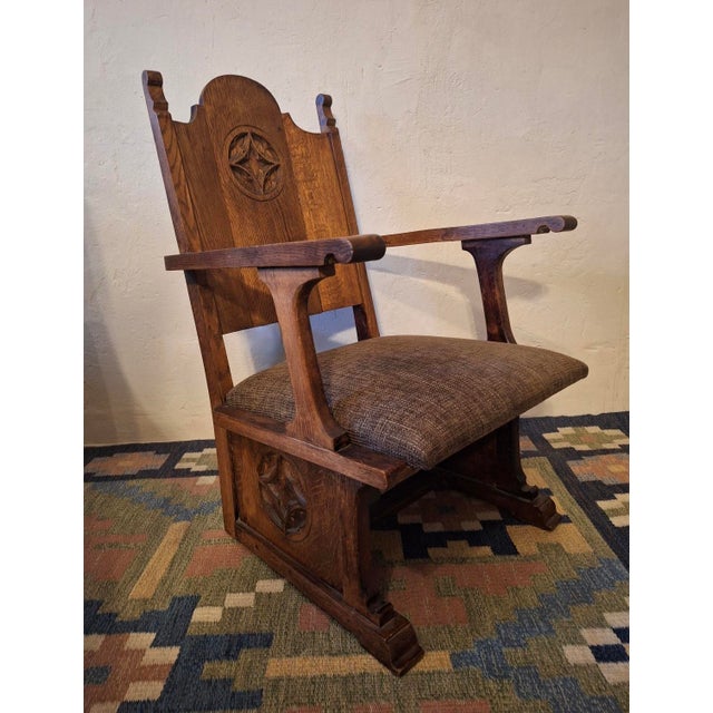 Gothic revival armchair in carved solid oak, wool-covered seat, dating from about 1910. Beautifully patinated oak.
