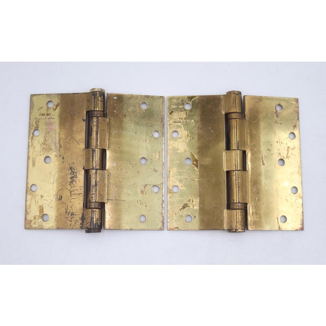 Stanley ball bearing polished brass door hinges with flat tips, five knuckles, and a staggered hole pattern. The original...