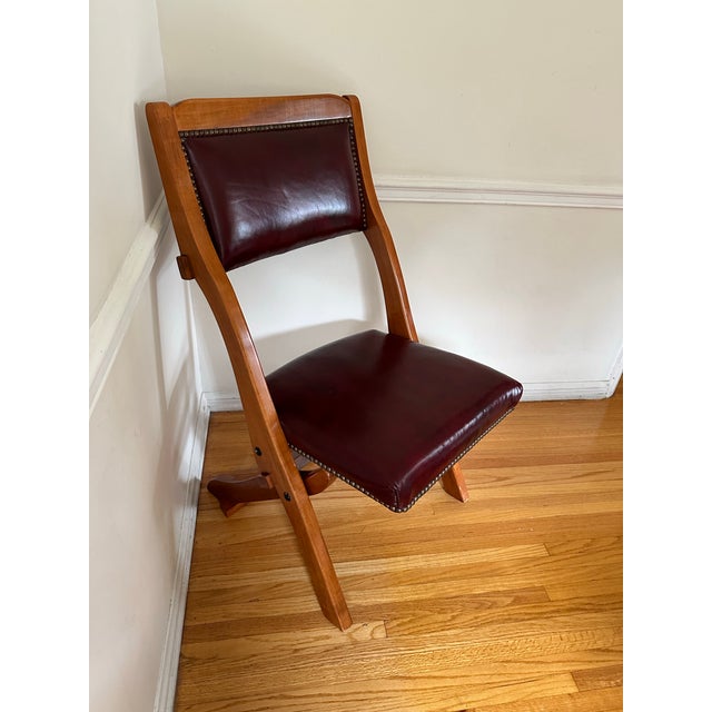 RMS Titanic Artifact Collection, Red Leather and Wood Chair. This is a reproduction of a deck chair from the Titanic ship....