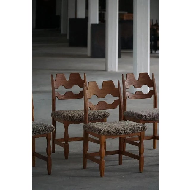 A beautiful and sculptural set of six oak dining chairs, designed by Henning (Henry) Kjærnulf for Nyrup Møbelfabrik in...