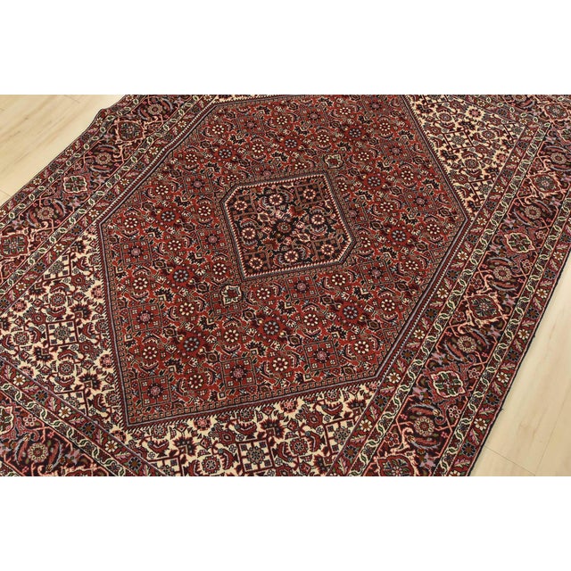 An authentic vintage traditional Bidjar rug hand-knotted with fine wool and natural dyes. This intricately woven rug...