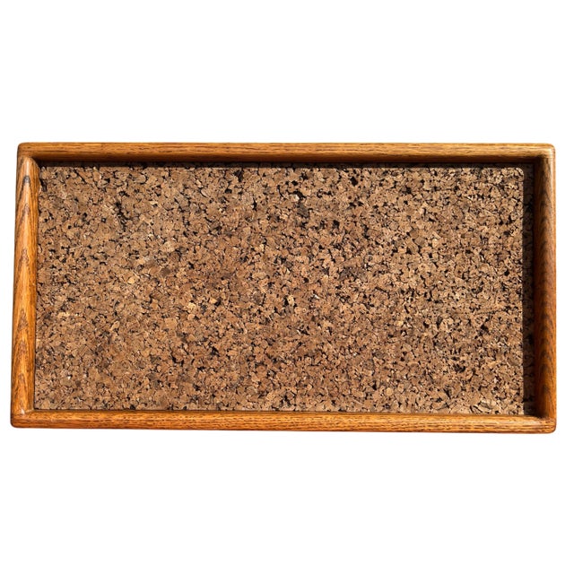 Handsome 1970s cork board, framed in richly grained solid oak. Featuring a dense natural cork surface, this board is both...