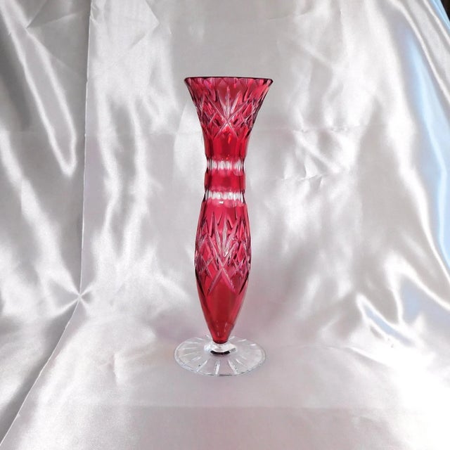 This is a dark pink cut to clear vase on a clear stand. The vase is tall and nicely shaped and cut with no wear to the...