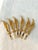 Glamorous set of six mid-century 24 karat gold plated Janis Collection cocktail forks with decorative figural feather...