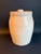 Antique Salt Glazed Stoneware Crock, cream to beige coloration, with lid decorated with tomato red knob. This heavy crock...