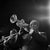 This black-and-white photo captures jazz legend Louis Armstrong playing his trumpet during a performance in Berlin in...