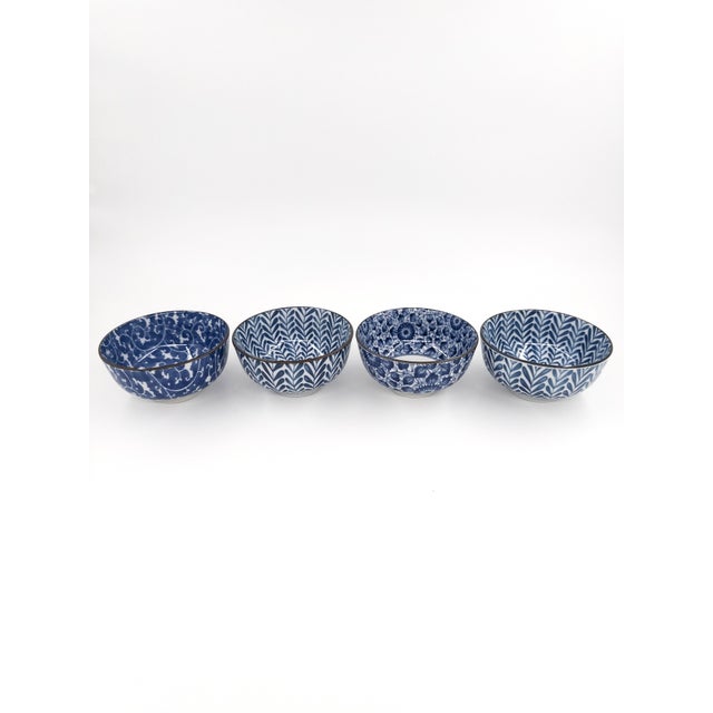 A gorgeous, curated set of four Japanese porcelain bowls, each featuring a distinct blue and white pattern. Crafted in...