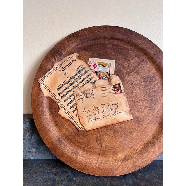 A whimsical turned wood plate with applied tromp l’oeil decals of playing cards. Signed on rear