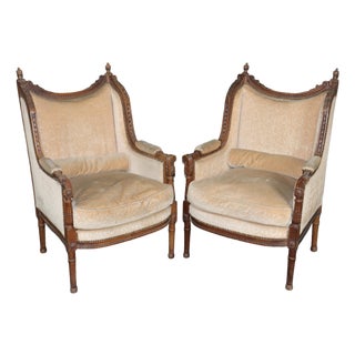 Pair of Antique French Louis XVI Bergère Chairs, Walnut Carved Frames With Down Cushions, Turn of the Century For Sale