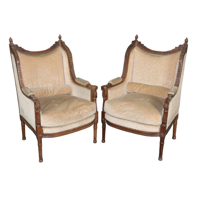Pair of Antique French Louis XVI Bergère Chairs, Walnut Carved Frames With Down Cushions, Turn of the Century For Sale