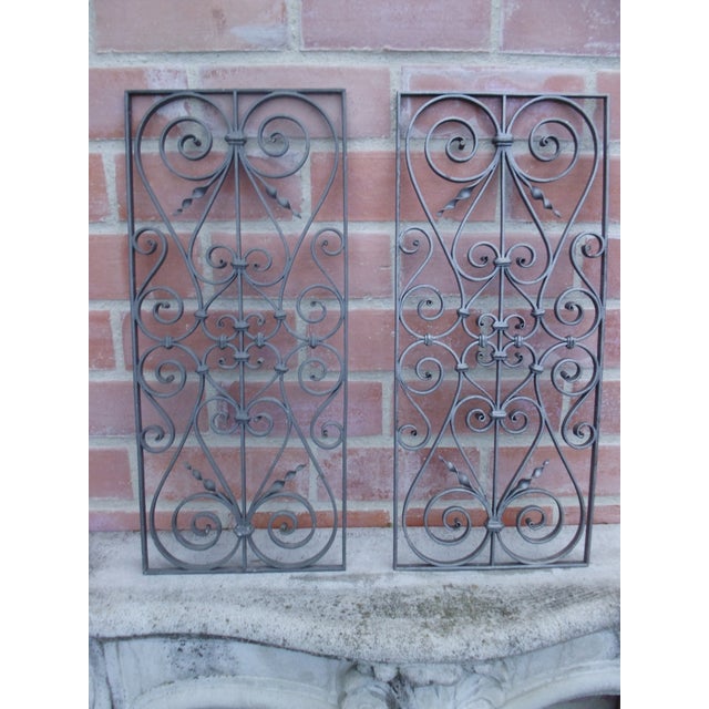 2 antique and hand-forged door grilles with authentic patina.