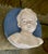 A round Plaque depicting the bust of a young boy in the " Della Robbia" Style from the Italian factory "Cantagalli" dating...