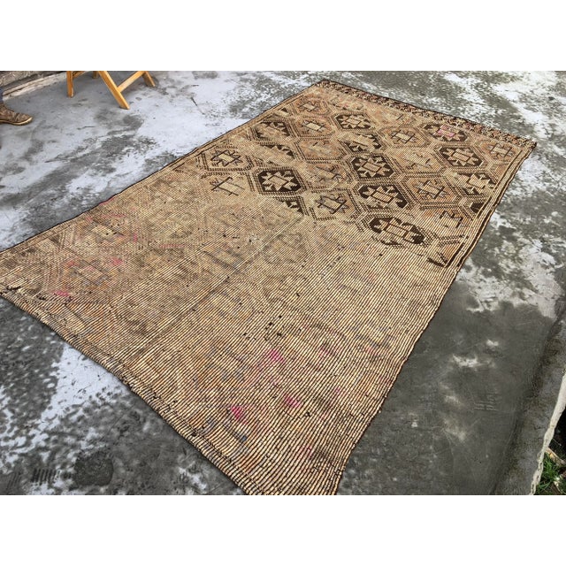 This is a vintage Turkish Anatolian kilim rug from the 1960s. The piece was hand-woven.
